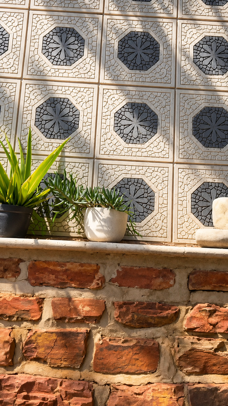 Plants beside a patterned garden wall